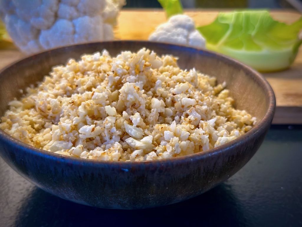 A brown bowl containing cauliflower rice