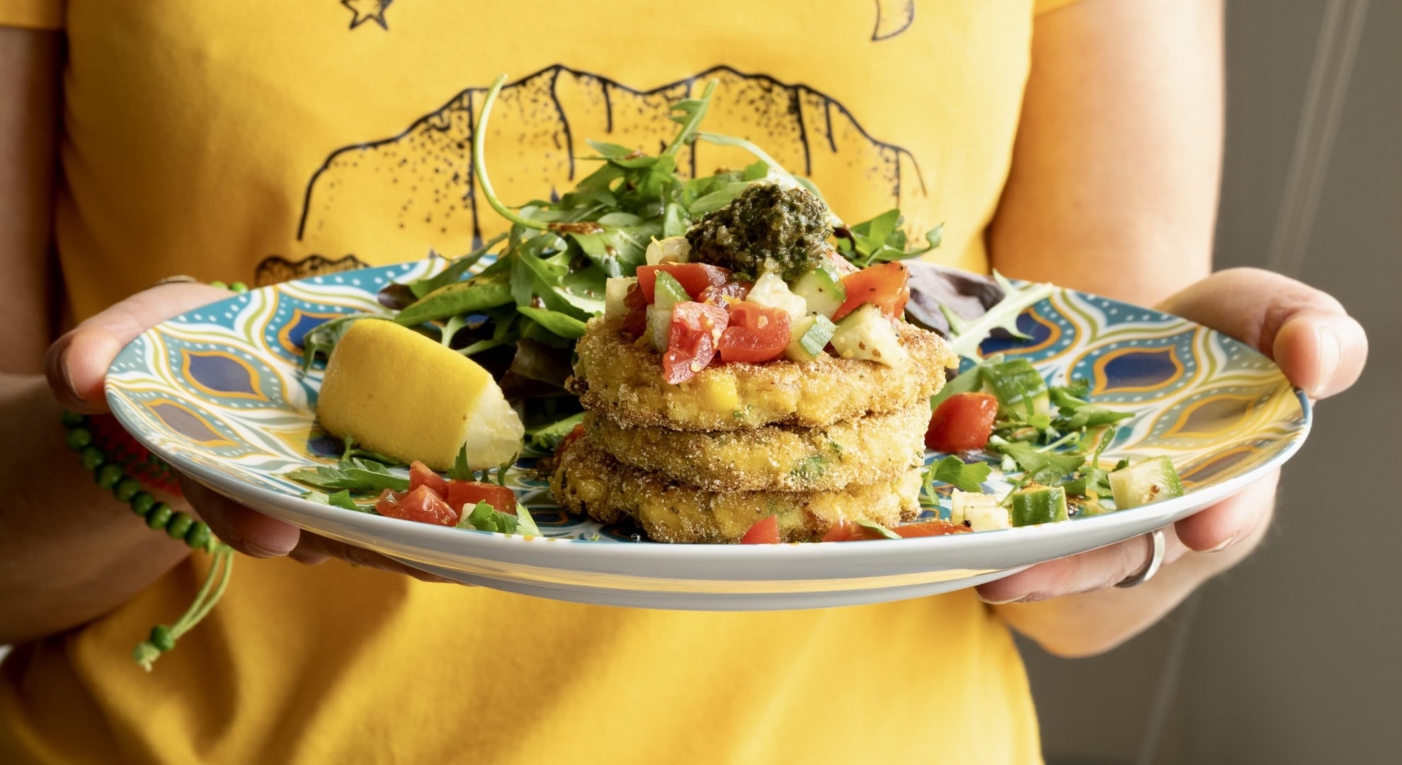 Sweetcorn fritters plated with salad — learn vegan cookery