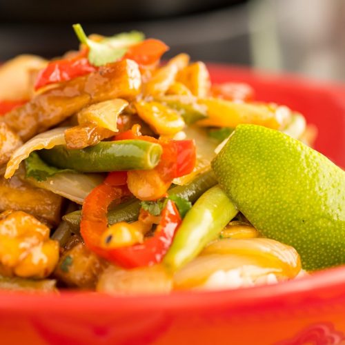 vegan stir-fry in a red bowl